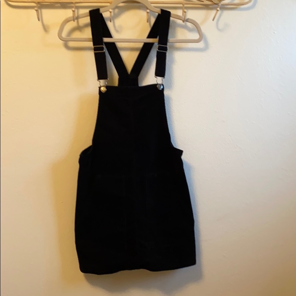 Black, corduroy overall jumper.